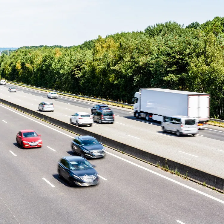 Heavy but fluid traffic on the A10 highway in France by a sunny day.