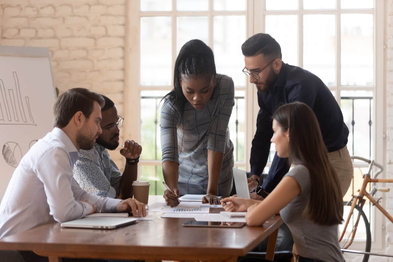Diverse colleagues working on project together lead by african female