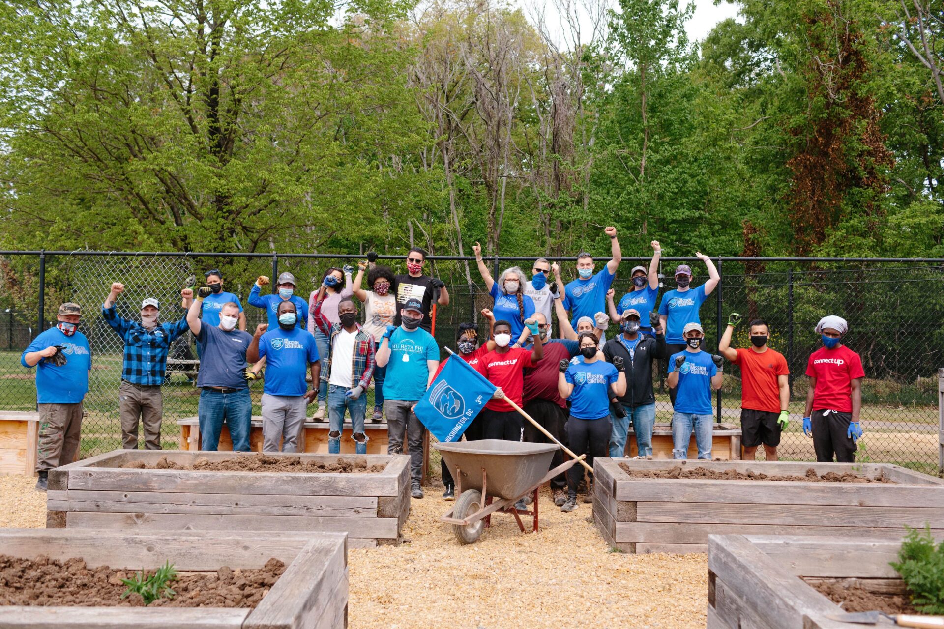 Group of volunteers planting trees at Aptive Resources community event.