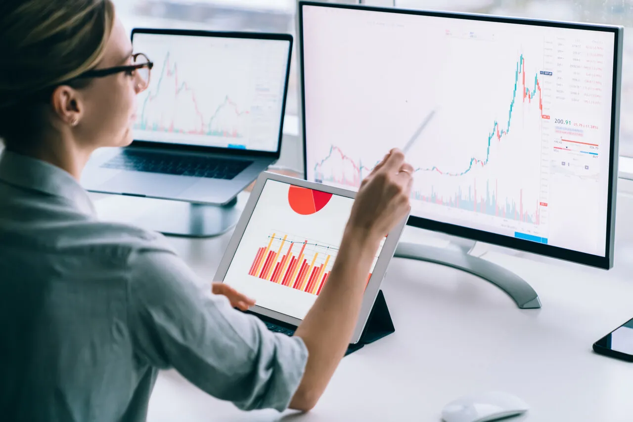 Crop businesswoman researching charts on computer
