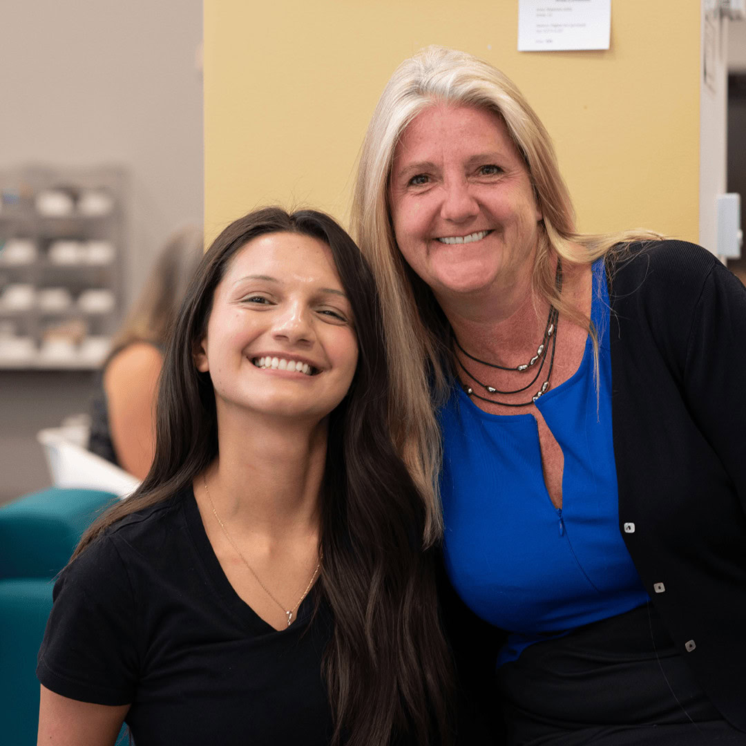 Mentoring session with two smiling women in an office setting.