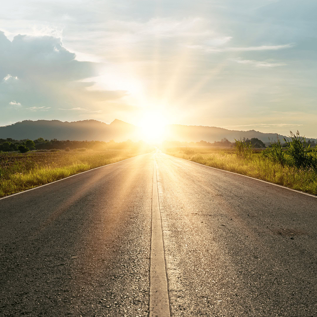 Sunrise over an open road symbolizing hope and new beginnings for mental health awareness.