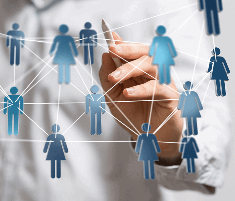 Businessman connecting digital icons of people representing networking and social connections.