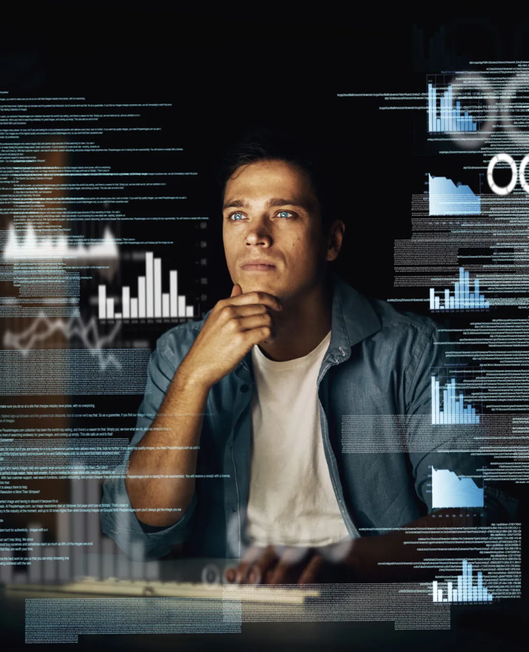 Cracking codes is not just his job but his passion. Cropped shot of a young computer programmer looking through data in the dark.