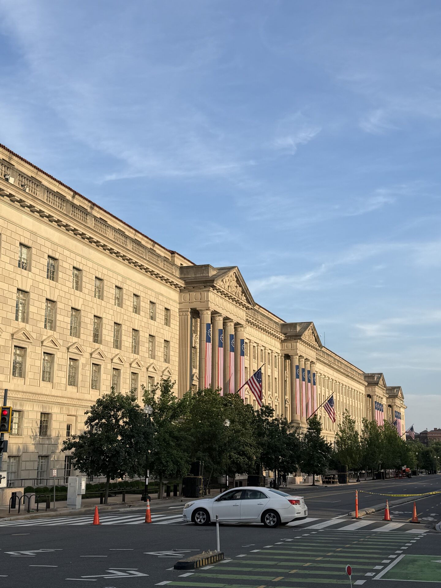 Historic building decorated with American flags for Independence Day celebration.