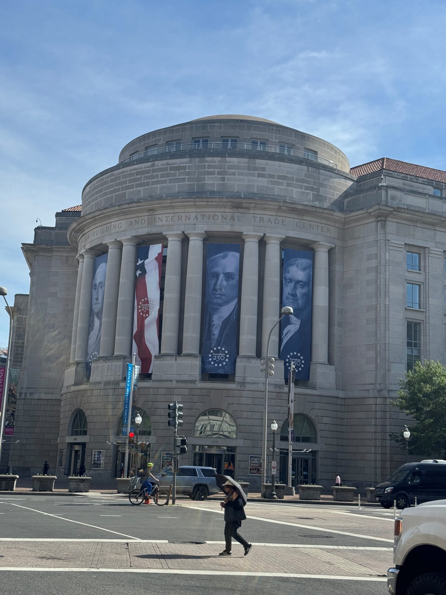 Historic building with large banners of George Washington, Abraham Lincoln, and other leaders.