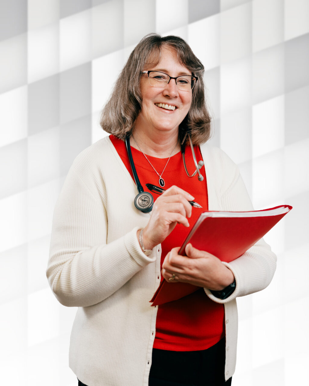 Smiling female healthcare professional with stethoscope and clipboard in bright room.
